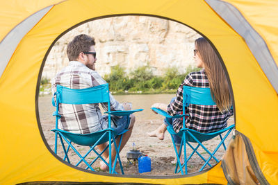 People sitting in yellow wheel