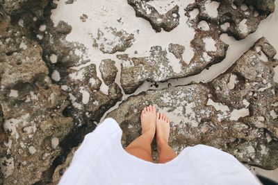 Low section of woman standing on beach