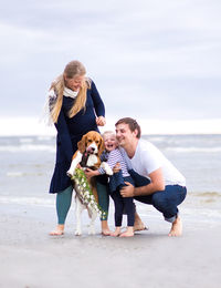 Full length of happy family at beach