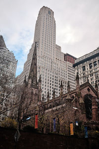 Low angle view of buildings against cloudy sky