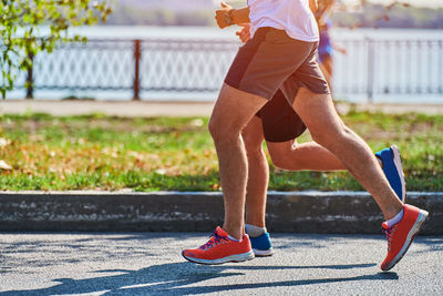 Low section of people running on road