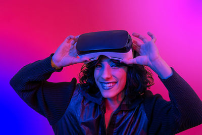 Woman is using the virtual reality viewer. portrait of woman with trendy look and bright colors.