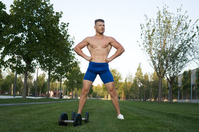 Full length of man exercising on field