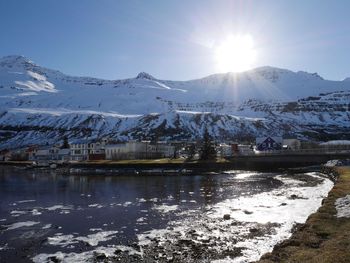 Scenic view of snowcapped mountains against bright sun