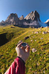 Rear view of man photographing against mountain