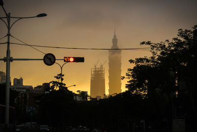 Silhouette of street lights at dusk