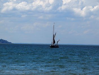 Man in sea against sky