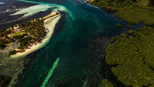 The photo captures a breathtaking view of a serene beach with crystal-clear waters.