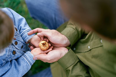 Midsection of woman holding snail