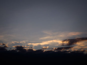 Low angle view of cloudy sky at sunset