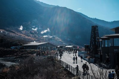 People on snow covered mountain against sky