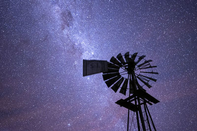 Low angle view of windmill against sky at night