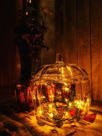 Close-up of illuminated christmas lights on table at home