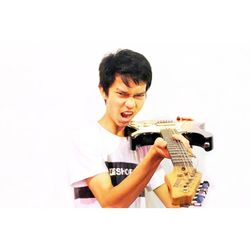 Young man holding camera over white background