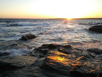 Scenic view of sea against clear sky during sunset