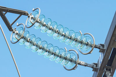 Low angle view of metallic structure against clear blue sky