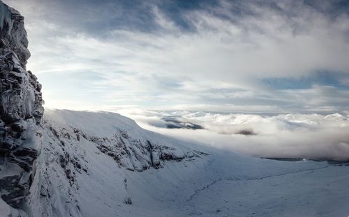 Scenic view of snow covered mountains against sky