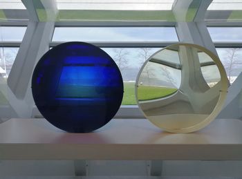 Close-up of glass window with reflection on table