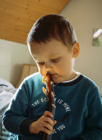 Portrait of cute boy playing guitar