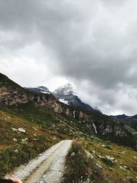 Road by mountain against sky