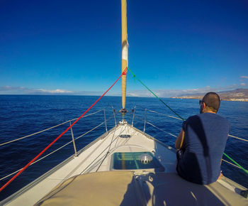 Sailboat sailing on sea against sky