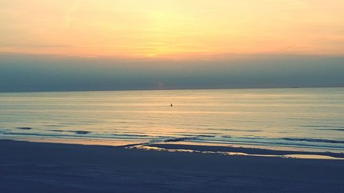 Scenic view of sea against sky at sunset