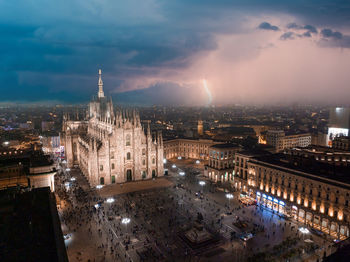 Aerial view of piazza duomo in front of the gothic cathedral in the center of milan at night.