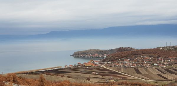 Panoramic view of townscape by sea against sky