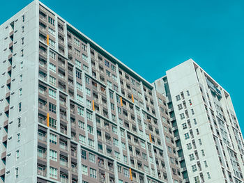 Low angle view of buildings against clear blue sky