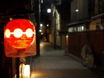 Close-up of illuminated road sign at night