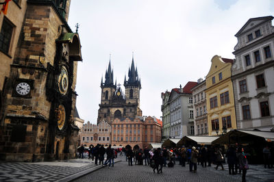 People walking on street amidst buildings in town