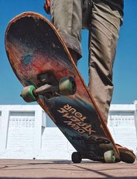 Low section of man standing on skateboard