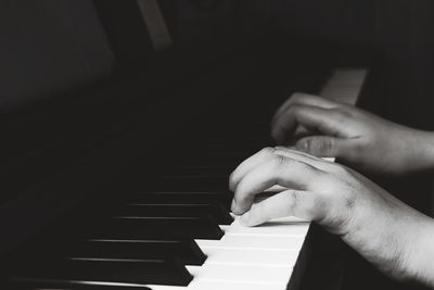 Midsection of person playing piano