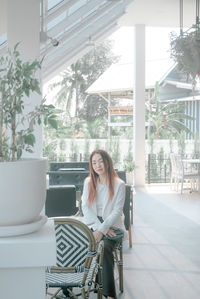 Portrait of young woman sitting on chair