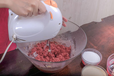 Cropped image of person mixing ingredients in bowl