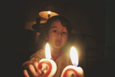 Close-up of baby boy in darkroom