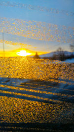 Close-up of yellow water against sky