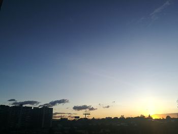Cityscape against clear sky during sunset