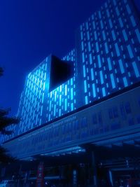 Low angle view of illuminated building against clear sky at night