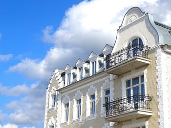 Low angle view of building against cloudy sky