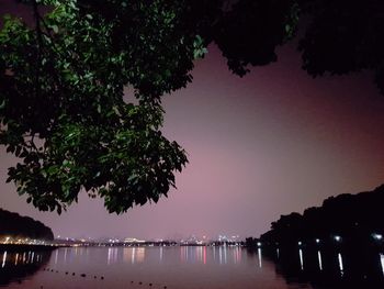 Scenic view of lake against sky at night