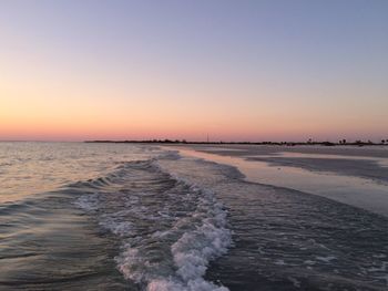 Scenic view of sea against clear sky during sunset