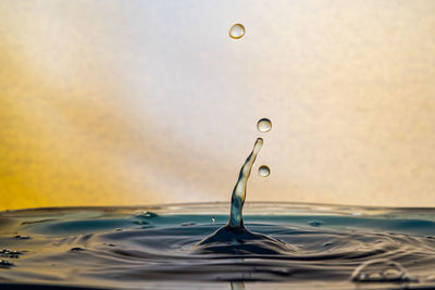 Close-up of drop falling on water