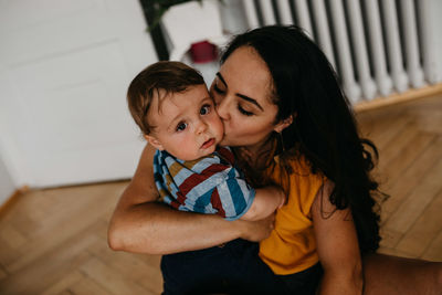 Midsection of mother and daughter at home