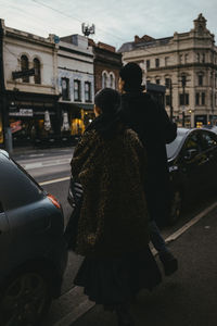 Rear view of people on city street