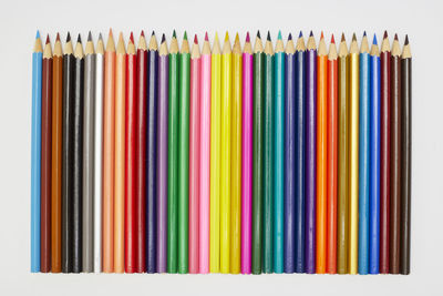 Close-up of colored pencils against white background