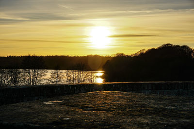 Scenic view of lake against sky during sunset
