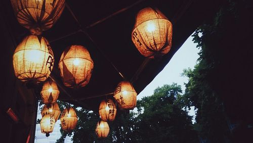 Low angle view of illuminated lights at night