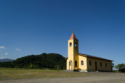 Low angle view of church against blue sky