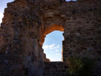 Low angle view of old ruin building against sky